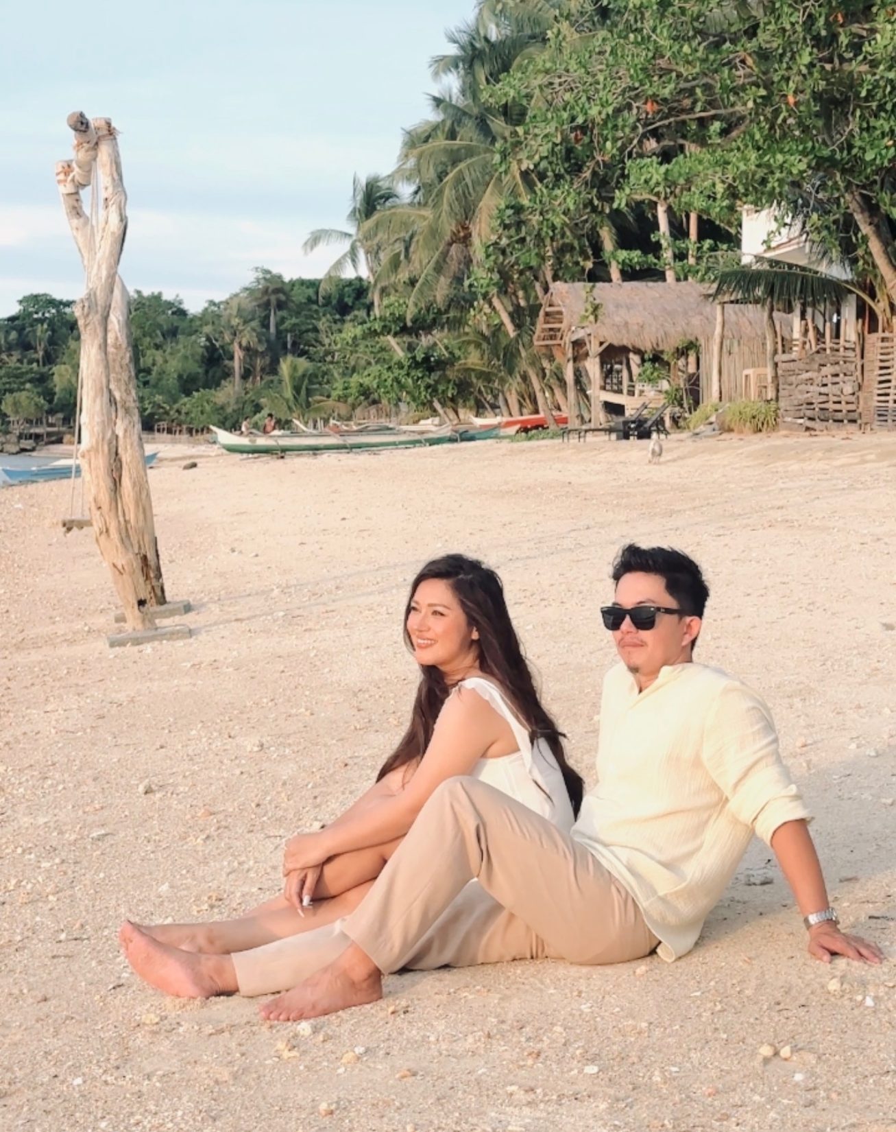 Mark and Lomi sitting together on the beach